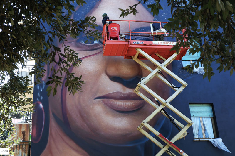 Jorit street artist painting in Rome Quarticciolo mural portrait Marielle Franco
