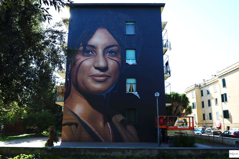 Jorit street artist painting in Rome Quarticciolo mural portrait Marielle Franco